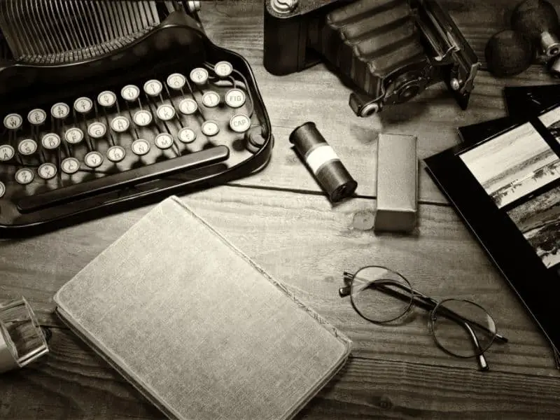 Moody photo of desk with typewriter and camera