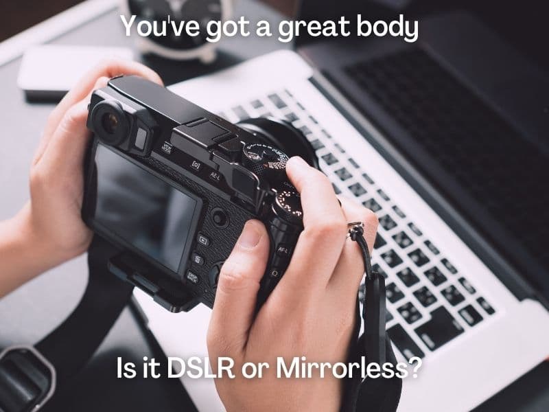 person holding a camera in front of laptop with photography pun