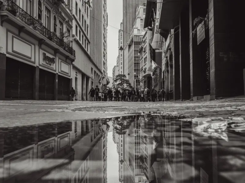 street photo of large city and puddle after the rain